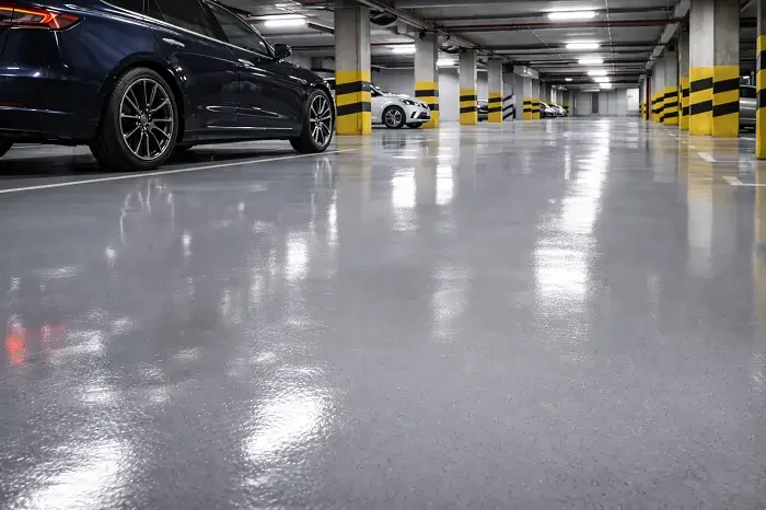 Glossy polyurethane garage flooring with cars in UAE multi-level parking facility
