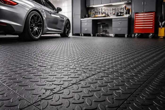 Heavy-duty rubber garage flooring tiles in textured finish for UAE workshop